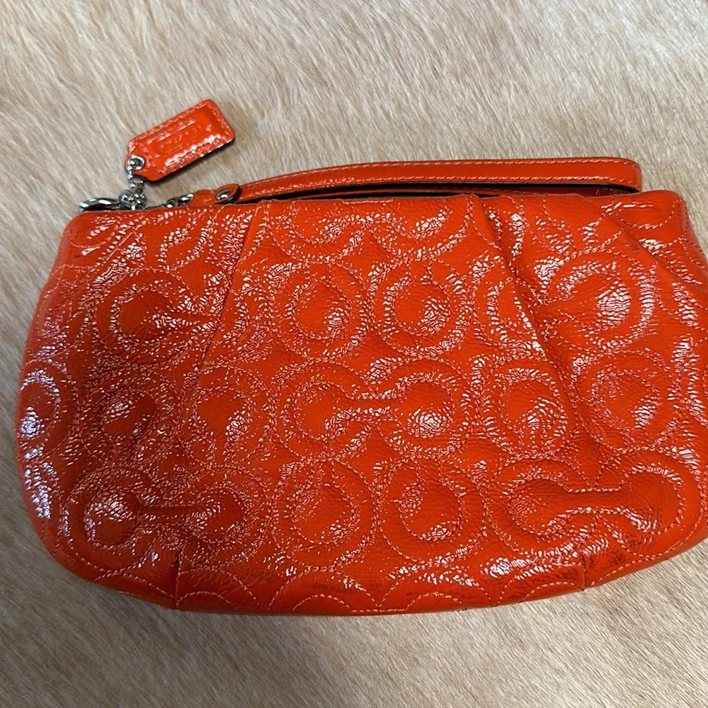 Coach - orange patent wristlet